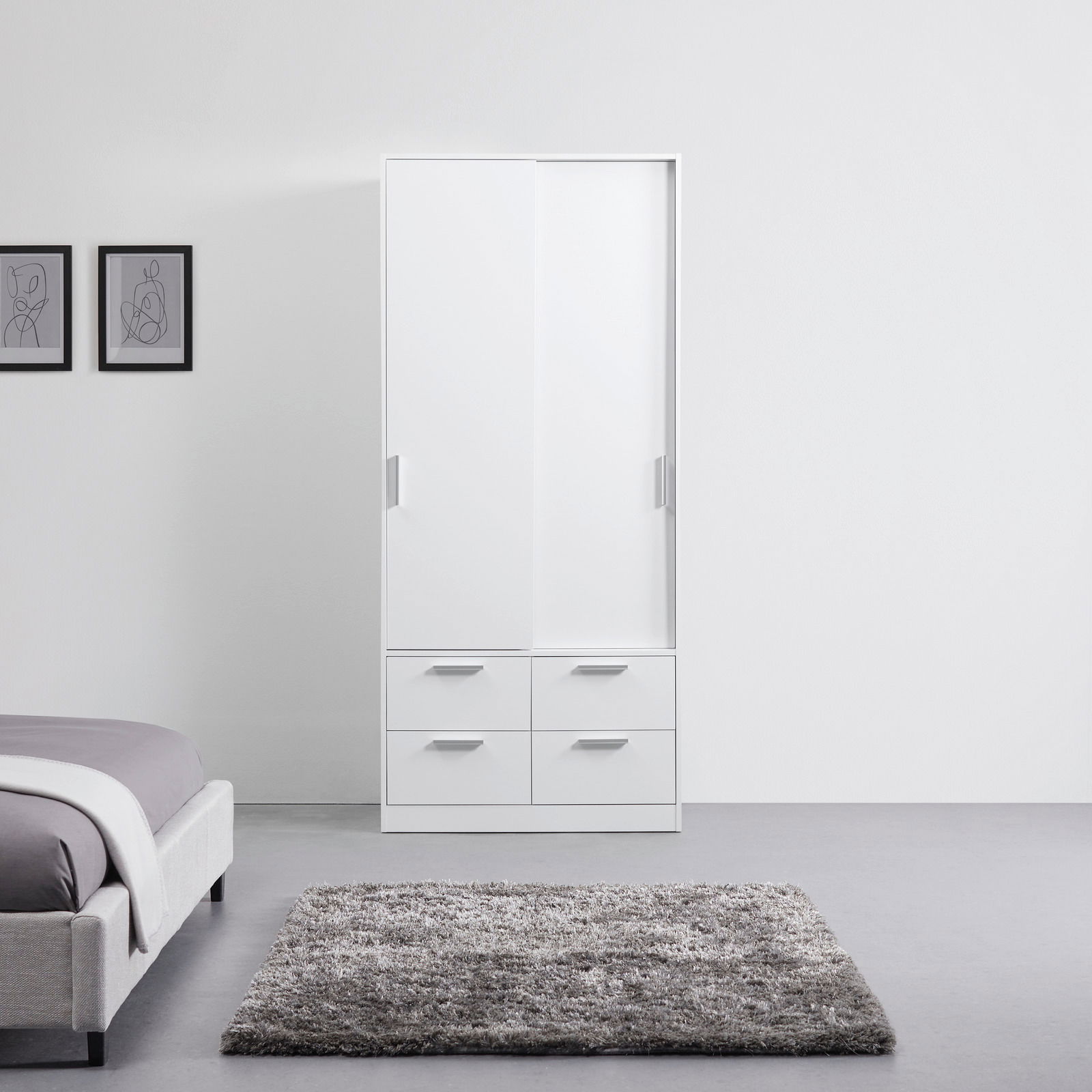 Weißer Schiebetürenschrank mit zwei Türen und vier Schubladen, frontal fotografiert in einem modernen Schlafzimmer.