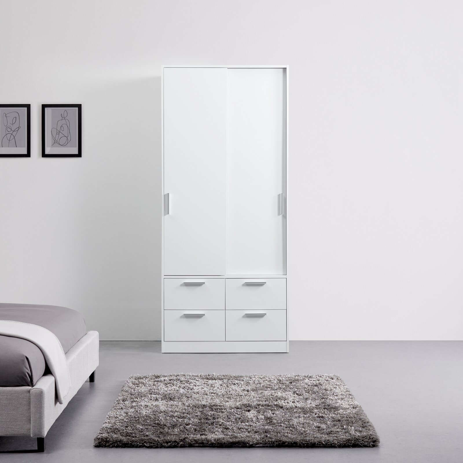 Weißer Schiebetürenschrank mit zwei Türen und vier Schubladen, frontal fotografiert in einem modernen Schlafzimmer.