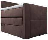 Nahaufnahme eines braunen Boxspringbetts von der Seite mit sichtbarer Matratze und Stoffbezug.