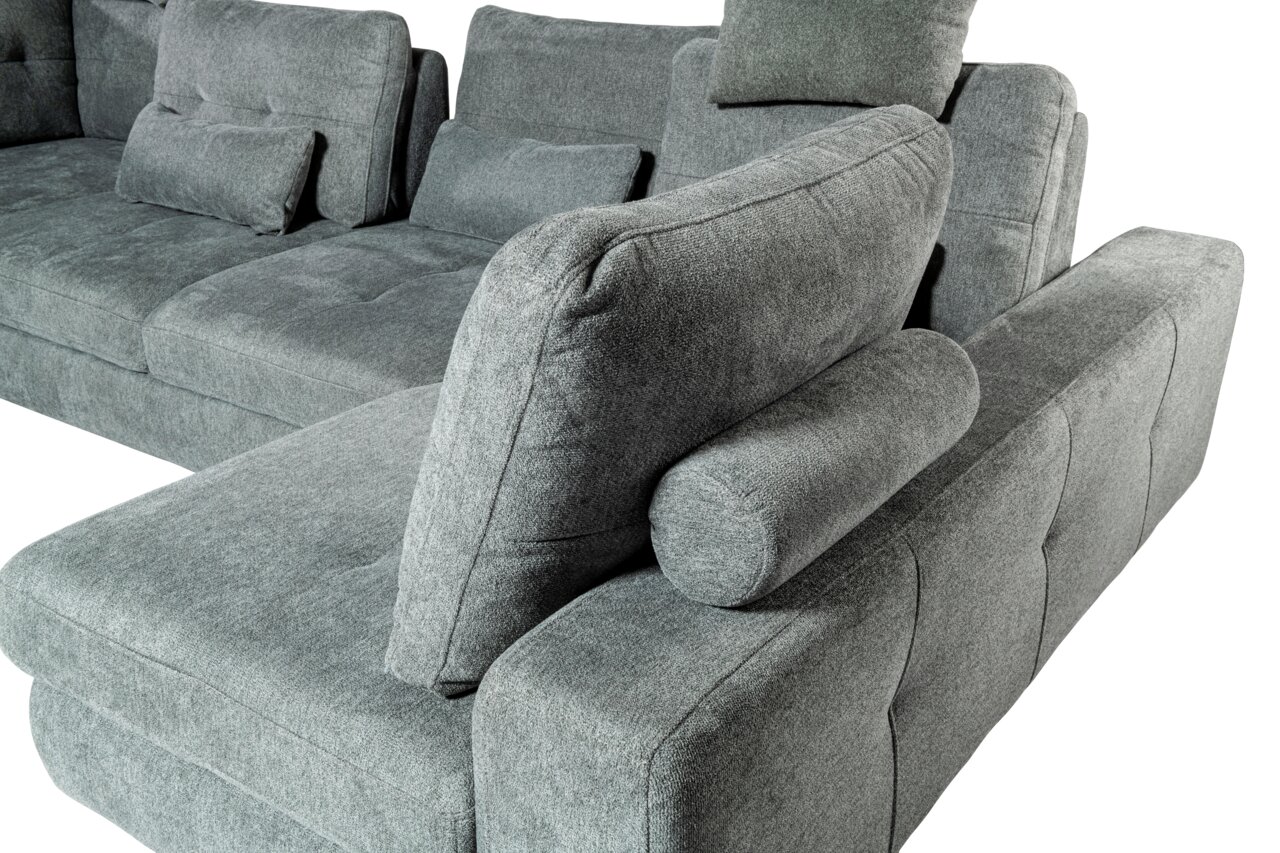 Graues Ecksofa mit Kissen und Polsterrollen, Perspektive von der Seite