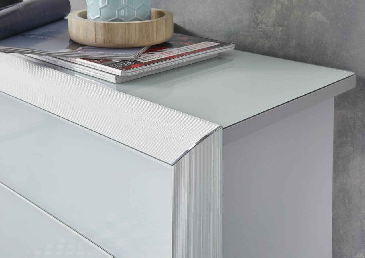 Nahaufnahme eines modernen Schuhschranks mit glänzender Glasoberfläche und eleganten Linien, von oben betrachtet.