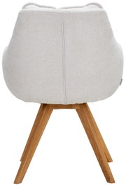 Achterkant van een fauteuil met een lichte stoffen bekleding en houten poten.