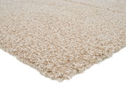 Nahaufnahme eines cremefarbenen Hochflor-Teppichs aus seitlicher Perspektive