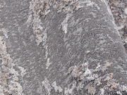 Nahaufnahme eines Designer Teppichs mit grauer und beiger Textur, seitliche Perspektive