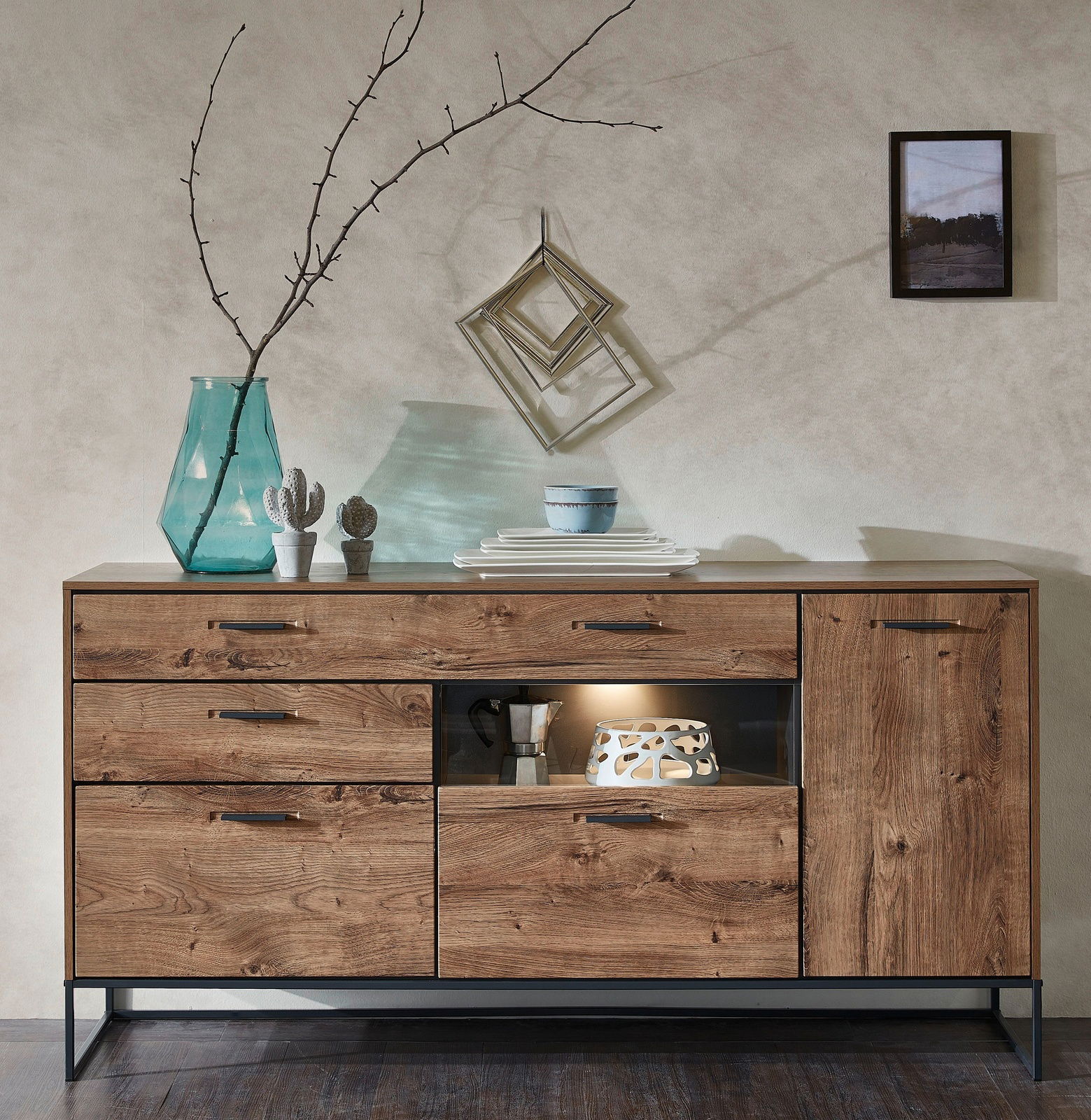 Holz-Sideboard mit mehreren Schubladen und Türen, dekoriert mit einer Vase, Geschirr und einem Kunstobjekt, aus frontaler Perspektive.