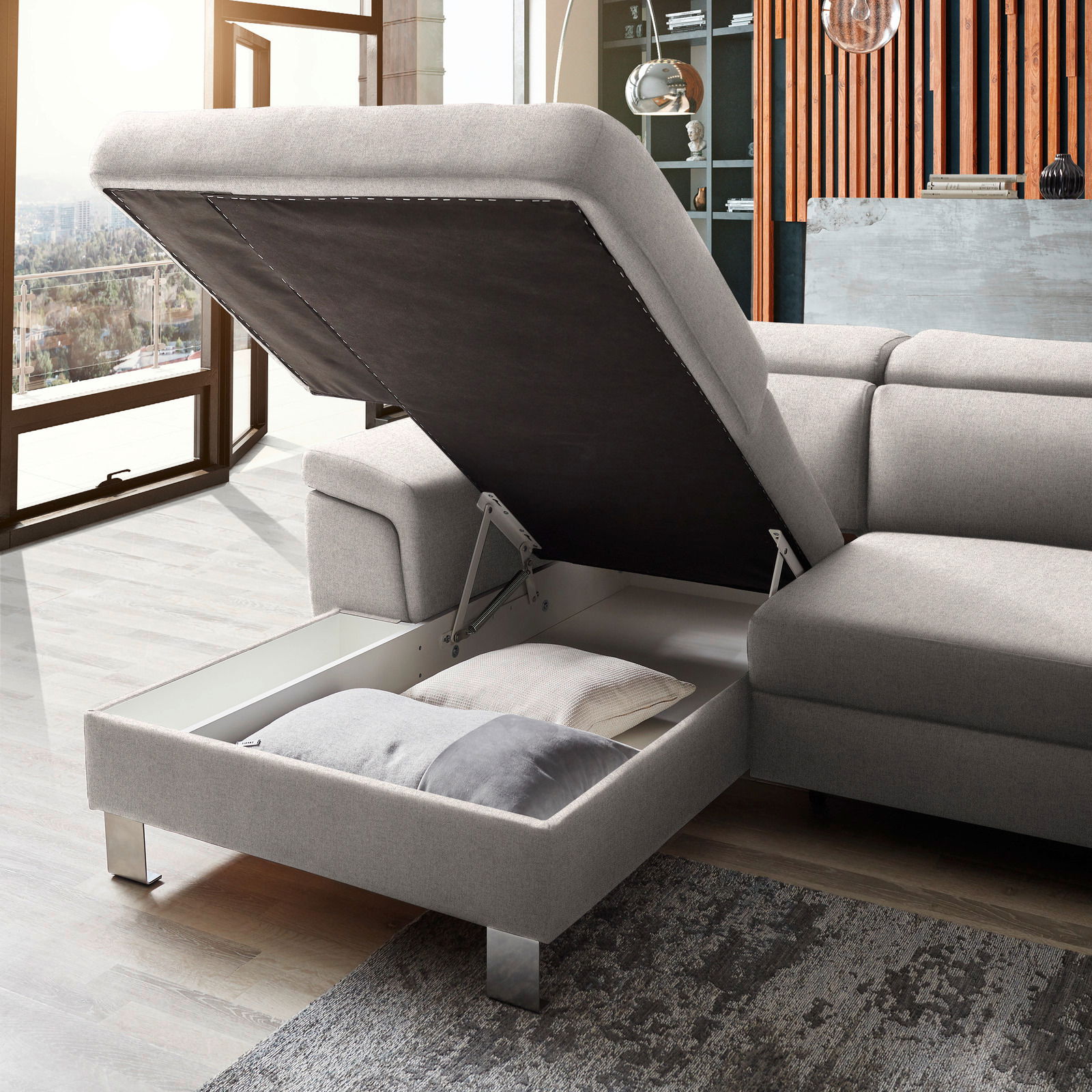 Rundecke in hellem Grau mit geöffneter Stauraumfunktion, seitliche Perspektive