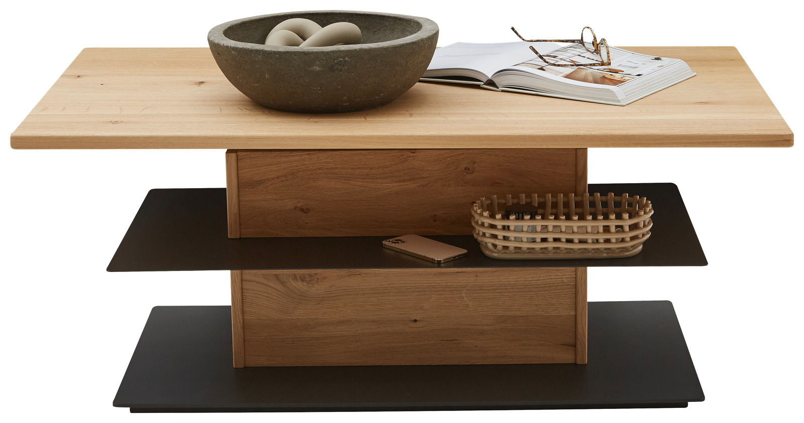 Moderner Couchtisch aus Holz mit zwei schwarzen Ablagen, dekoriert mit einer Schale, einem Buch und einer Brille, frontal betrachtet.