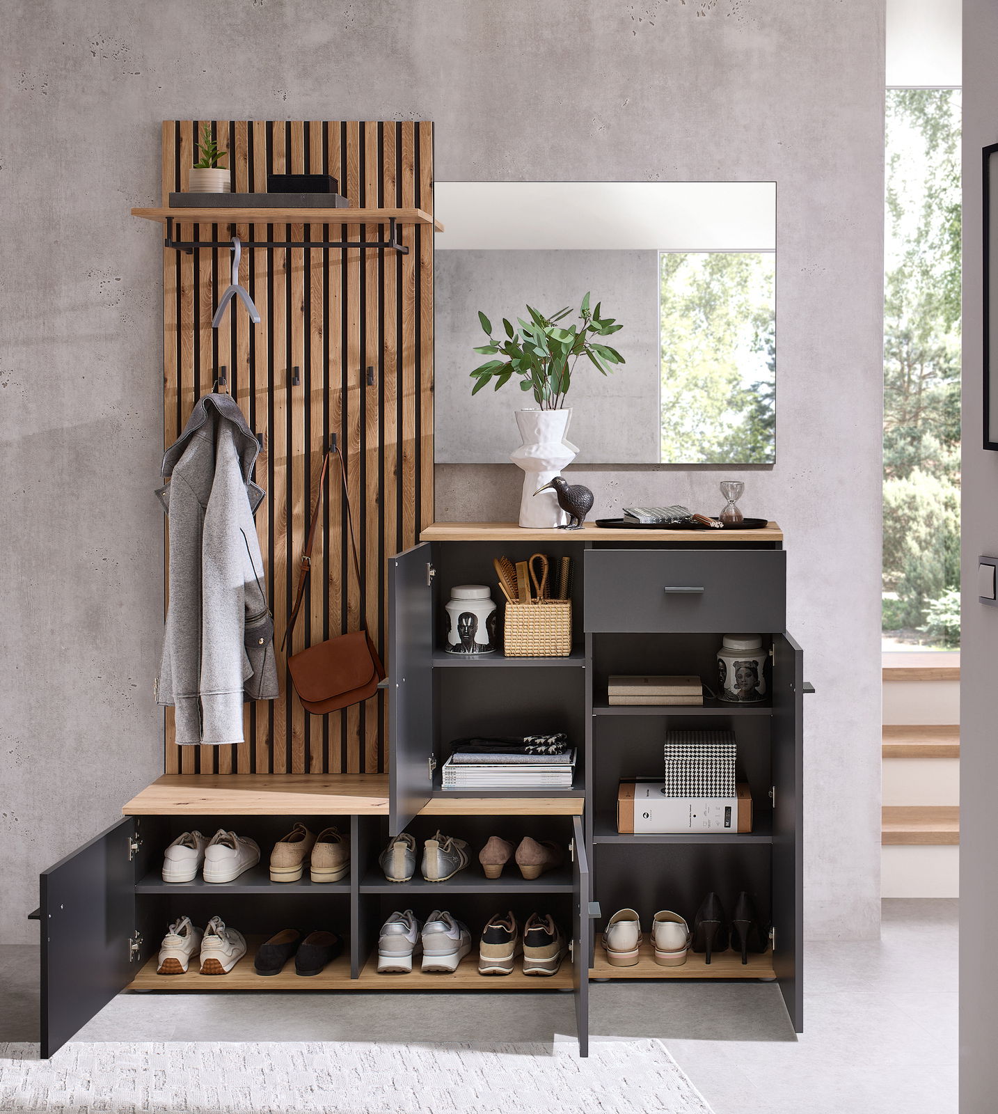 Kompaktgarderobe mit Holz- und Metallelementen, inklusive Schuhregal, Kleiderhaken und Spiegel, aus der Frontalperspektive fotografiert.