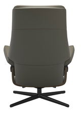 Rückansicht eines modernen Einzelsessels mit drehbarem Fußgestell in dunklem Farbton.