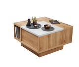 Moderner Couchtisch VAN COUVER aus Holz mit weißer Ablagefläche, dekoriert mit Tabletts, Kerzen und Pflanzen, seitliche Perspektive.