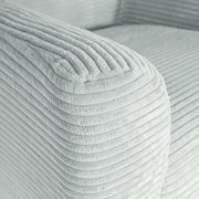 Nahaufnahme der abgerundeten Armlehne eines hellgrauen Cordstoff-Sofas mit gerippter Struktur, Perspektive: schräg von oben