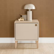 Frontale Ansicht einer modernen Nachtkonsole in Beige mit Holzbeinen, dekoriert mit einer Tischlampe und einem Spielzeugauto.