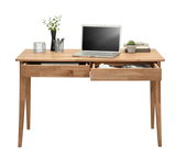 Moderner Holzschreibtisch mit zwei offenen Schubladen, Laptop, Pflanzen und Schreibutensilien, Frontalansicht.