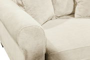 Nahaufnahme eines beigen Funktionssofas mit geripptem Stoffbezug, Blick auf die Armlehne und Sitzfläche.