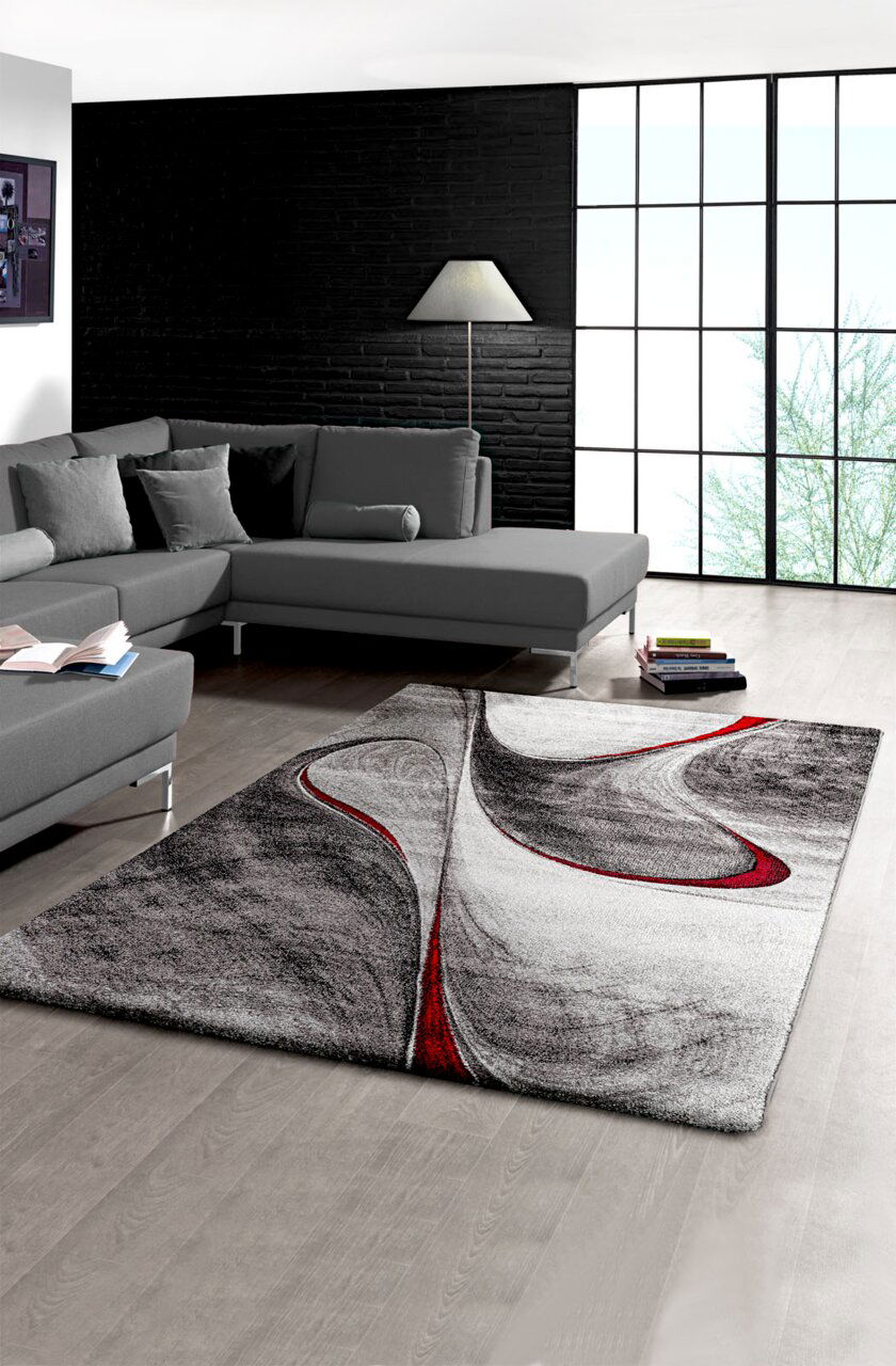 Merinos Teppich 120x170 cm PHÖNIX Moderner Teppich mit abstraktem Design in Schwarz, Weiß und Rot in einem stilvollen Wohnzimmer, Perspektive von oben.