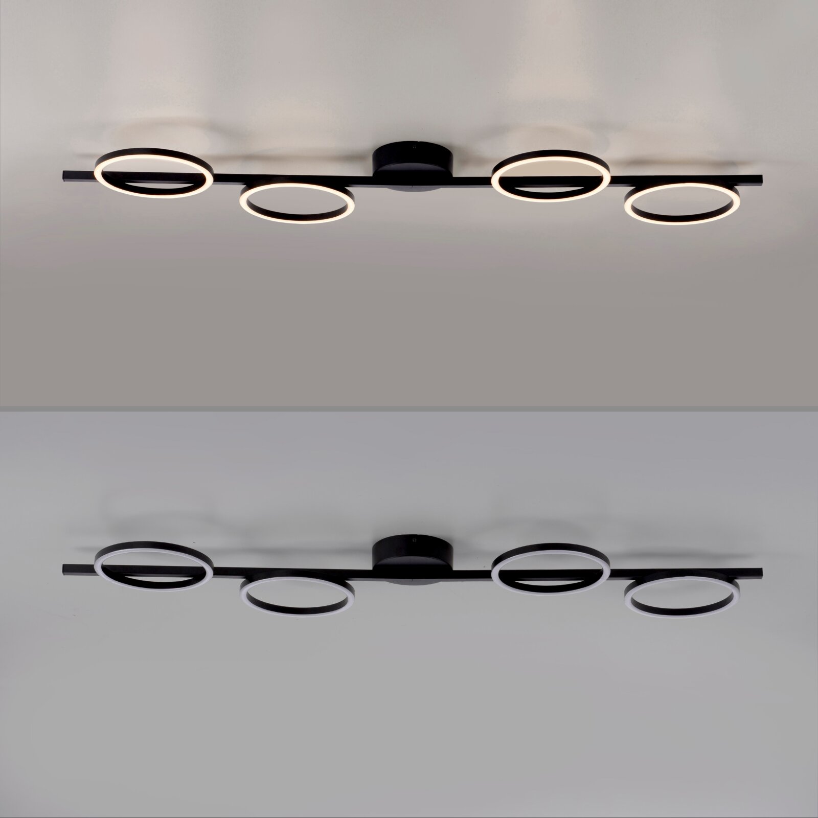 Moderne schwarze LED-Deckenleuchte mit vier ringförmigen Lichtquellen an einer geraden Schiene, warmweiß leuchtend, Ansicht von unten (Untersicht) an der Decke montiert.