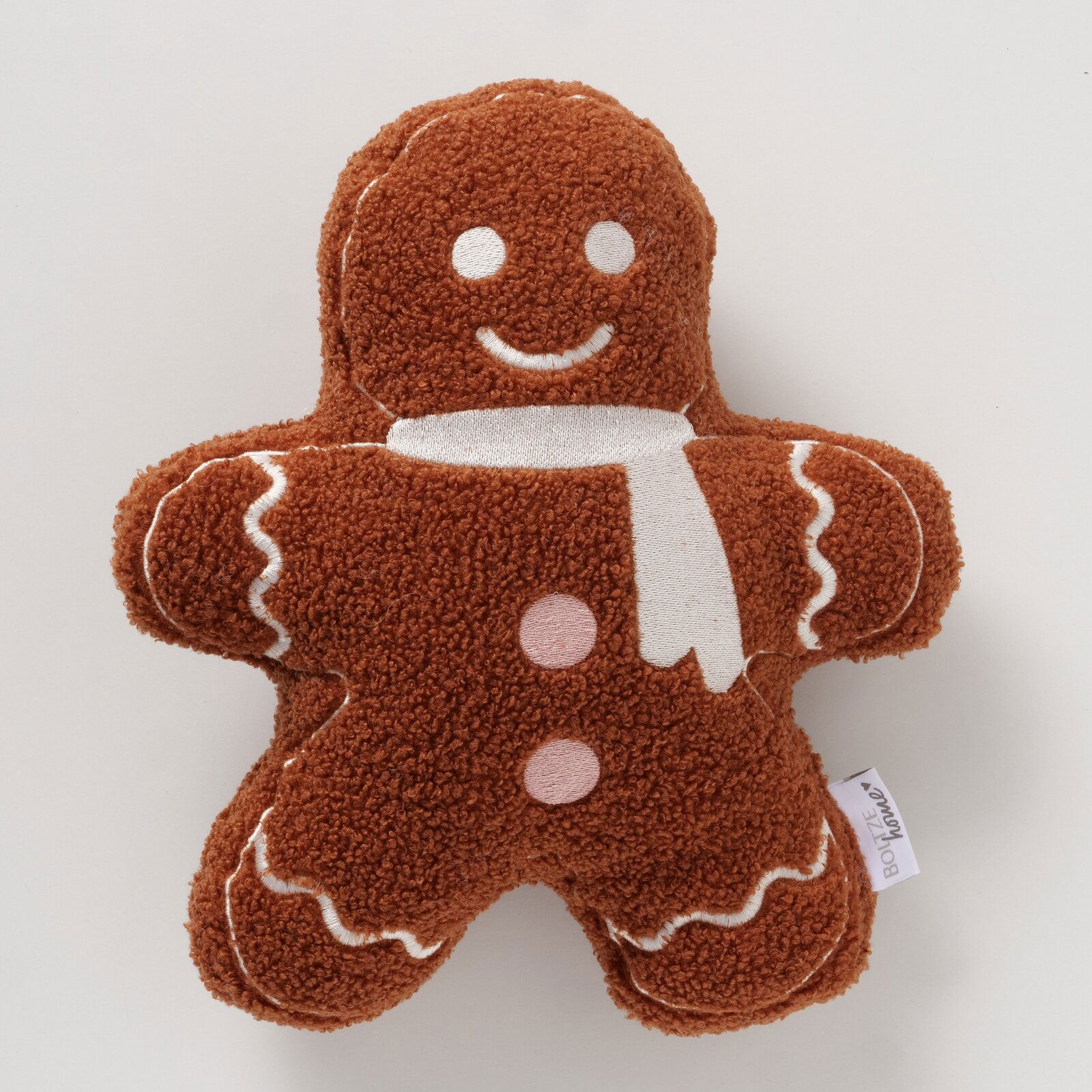 Boltze Kissen GINGER Kissen in Form eines Lebkuchenmanns aus braunem Polyester mit weißen und rosa Details, von oben betrachtet.