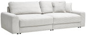 Großes, hellgraues Sofa mit geripptem Stoffbezug, zwei großen Sitzkissen und mehreren Rückenkissen, seitliche Perspektive
