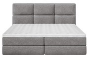 Graues Boxspringbett mit gepolstertem Kopfteil, Vorderansicht
