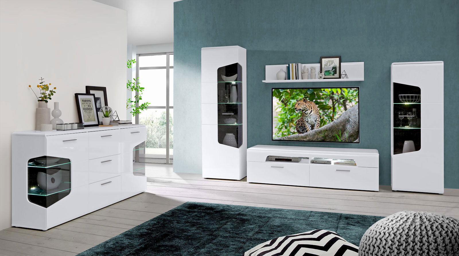 Moderne Wohnzimmermöbel in Weiß mit Vitrine, TV-Lowboard und Sideboard, frontal betrachtet.