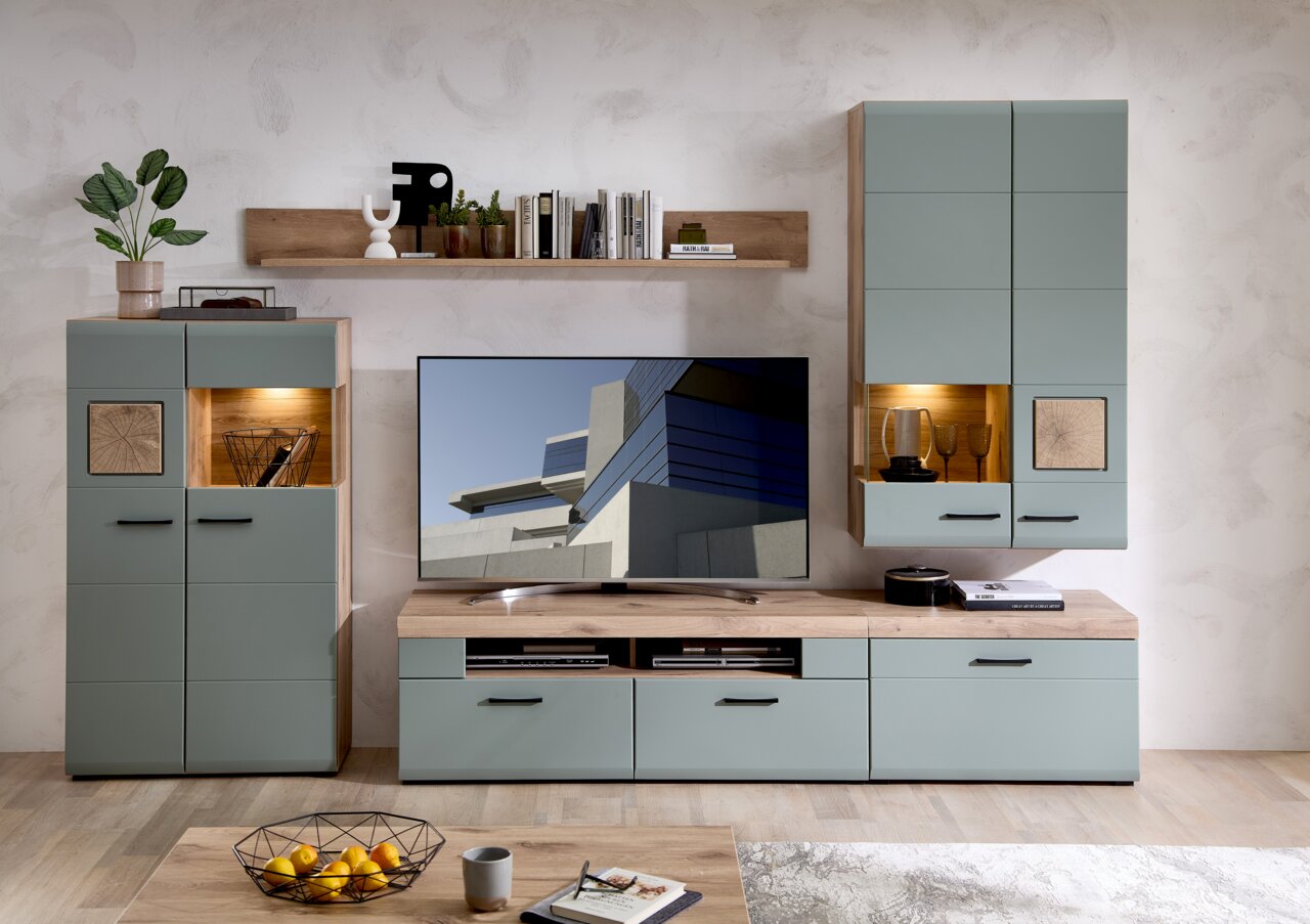 Moderne Wohnwand in hellem Holz und graublauen Fronten, bestehend aus Hängeschränken, einem TV-Board und einem Regal, frontal fotografiert.