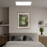 LED-Paneel TAVA A von Briloner an der Decke eines modern eingerichteten Schlafzimmers, frontal betrachtet.