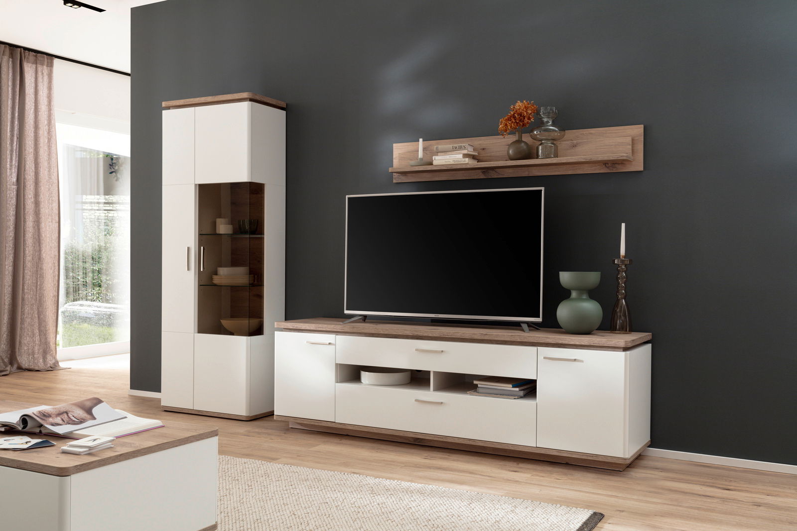 Moderne Wandkombination in hellem Holz und Weiß mit TV-Schrank, Vitrine und Wandregal, seitliche Perspektive