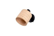 Wandlampe mit zylindrischem, geflochtenem Rattan-/Bambus-Lampenschirm in Naturfarbe und schwarzer Wandhalterung, schräg von vorne in leicht seitlicher Perspektive freigestellt
