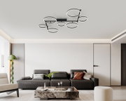 Moderne led-plafondlamp met meerdere ronde lichtringen, van onderaf gezien in een stijlvolle woonkamer.