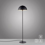 Schwarze Stehleuchte mit halbkugelförmigem Lampenschirm und rundem Standfuß, eingeschaltet, mit Kabel; frontale Ansicht auf neutralgrauem Hintergrund