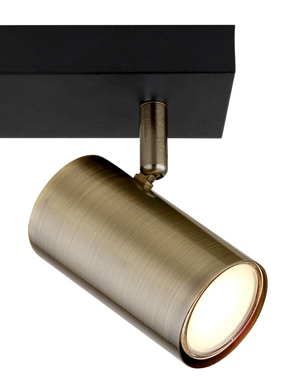 Strahler in Altmessing mit zylindrischem Design, von unten betrachtet, montiert an einer schwarzen Deckenhalterung.