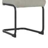 Nahaufnahme eines Schwingstuhls mit schwarzem Metallgestell und hellgrauem, geripptem Sitzbezug, seitliche Perspektive