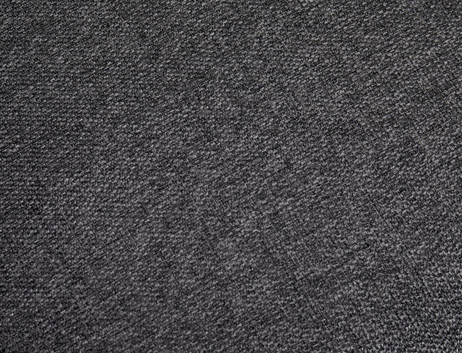 Nahaufnahme eines grauen Stoffes mit feiner Textur, perspektivisch von oben betrachtet.