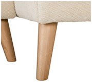 Detailansicht aus seitlicher Perspektive: Holzbeine eines Polstermöbels mit cremefarbenem Bouclé-Bezug