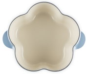 Blumenförmige Keramik-Auflaufform in Creme mit hellblauen Griffen, Draufsicht von oben auf weißem Hintergrund