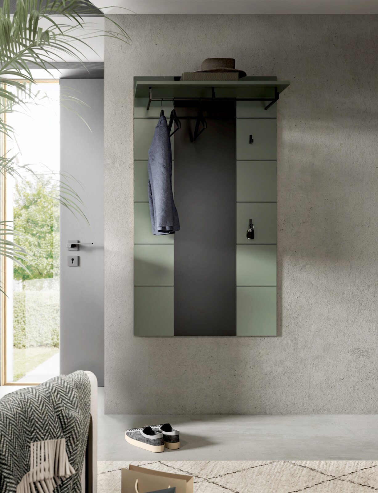 Wandgarderobe im modernen Design in Salbeigrün mit mittigem Spiegel, Ablage und Kleiderstange mit Bügeln, frontal aus leicht erhöhter Perspektive fotografiert.