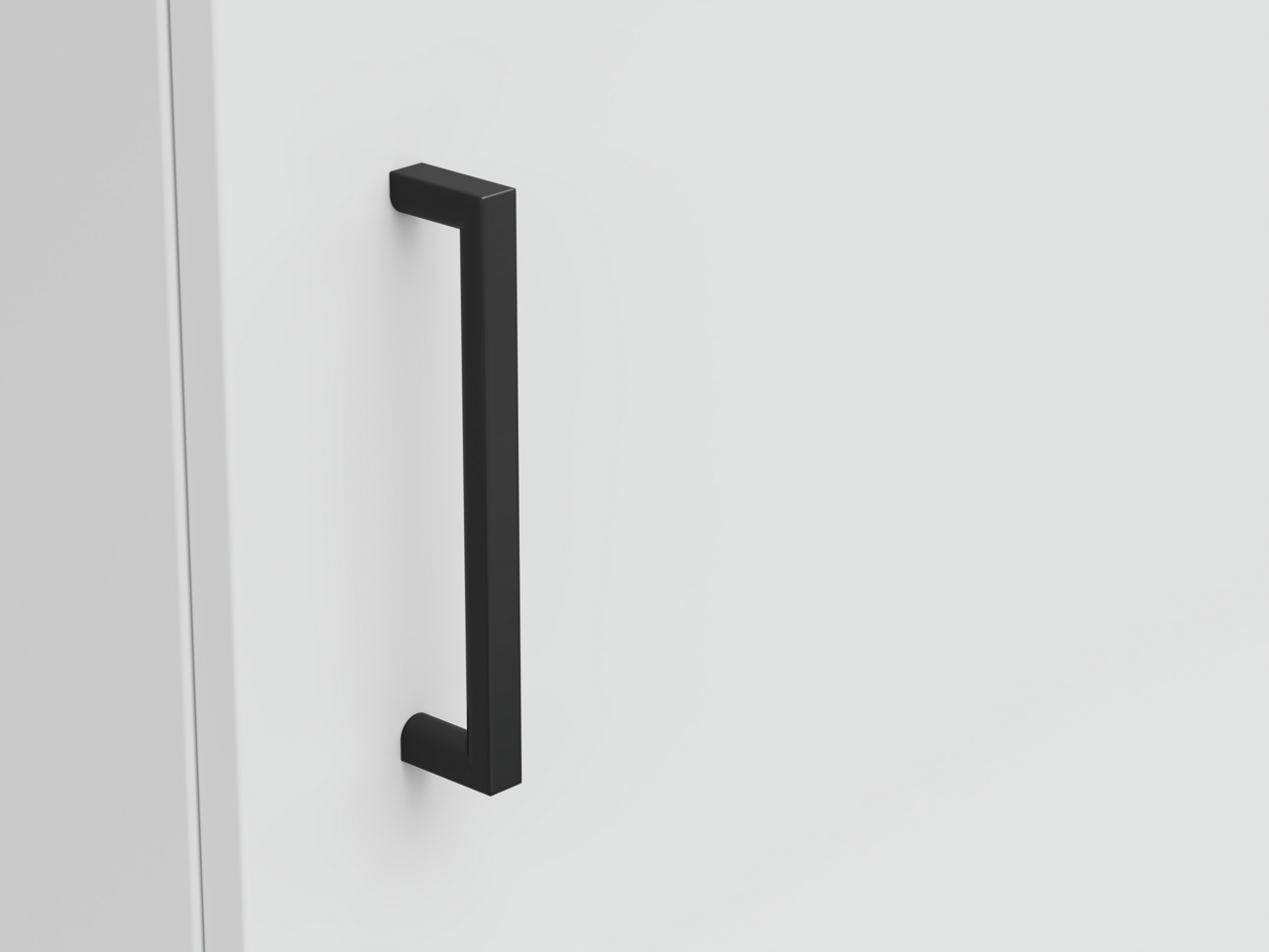 Nahaufnahme eines schwarzen Griffs an einer weißen Kommode, seitliche Perspektive