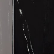 Nahaufnahme eines Beistelltisches mit schwarzer, marmorierter Oberfläche, seitliche Perspektive