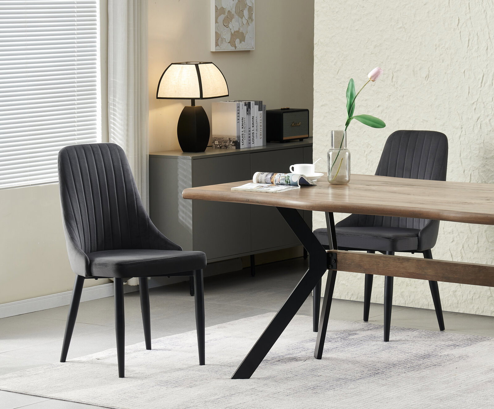 MID.YOU Stuhl 2er-Set CLAUDIA Schwarzer Polsterstuhl mit vertikaler Steppung neben einem Holzesstisch mit schwarzem Metallgestell in modernem Esszimmer, seitliche Perspektive