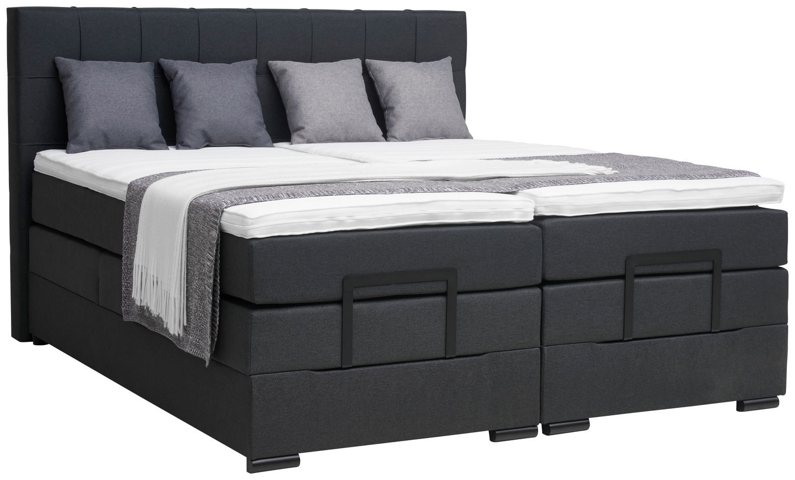 Boxspringbett in dunklem Stoffbezug mit vier Kissen und einer Decke, seitliche Perspektive