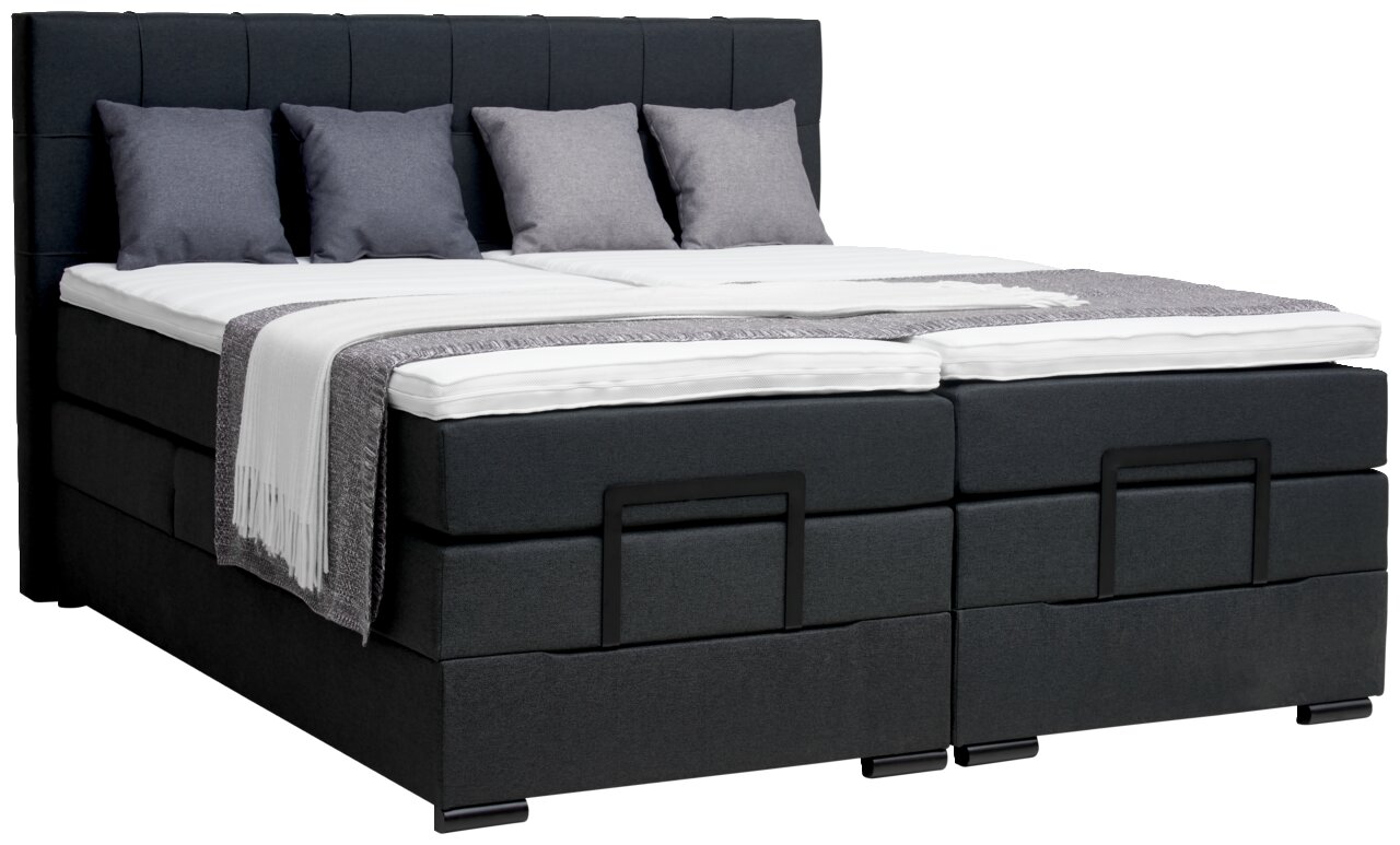 Boxspringbett in dunklem Stoffbezug mit vier Kissen und einer Decke, seitliche Perspektive