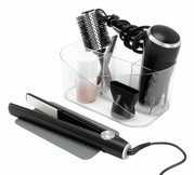 Doorzichtige opberghouder voor haarstylingtools met vakjes, gevuld met een föhn, ronde borstel en stijltang, gezien vanaf de voorkant.
