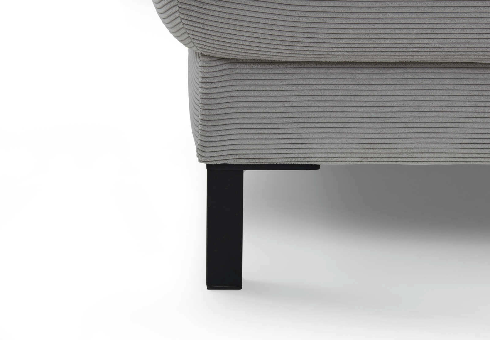 Nahaufnahme einer grauen Eckgarnitur mit geripptem Stoffbezug und schwarzem Metallfuß, seitliche Perspektive.