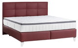 Boxspringbett mit rotem Kopfteil und weißer Matratze, seitliche Perspektive