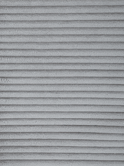 Nahaufnahme eines grauen, gerippten Stoffes, möglicherweise für einen Schwingstuhlbezug.