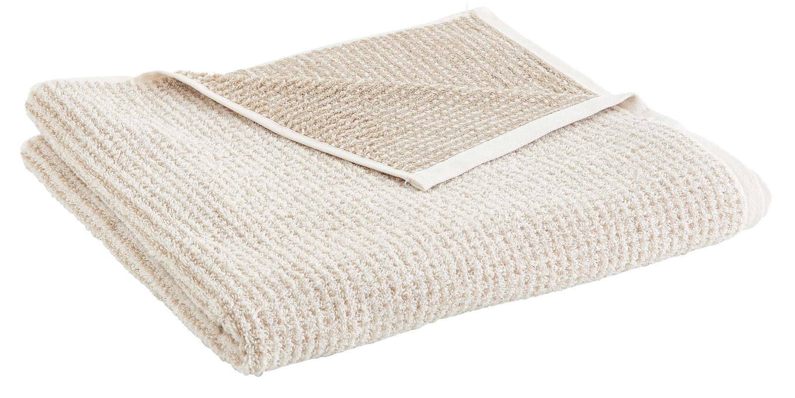 Beiges, gefaltetes Duschtuch aus Baumwolle, Nahaufnahme von schräg oben