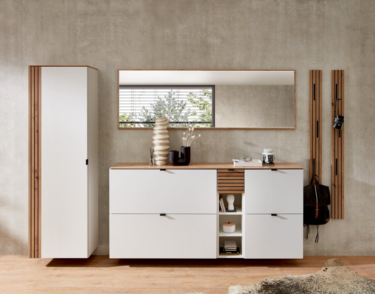 Moderne Garderobeneinrichtung mit weißem Hängeschrank, Spiegel und Schuhschrank in einer stilvollen, minimalistischen Perspektive.