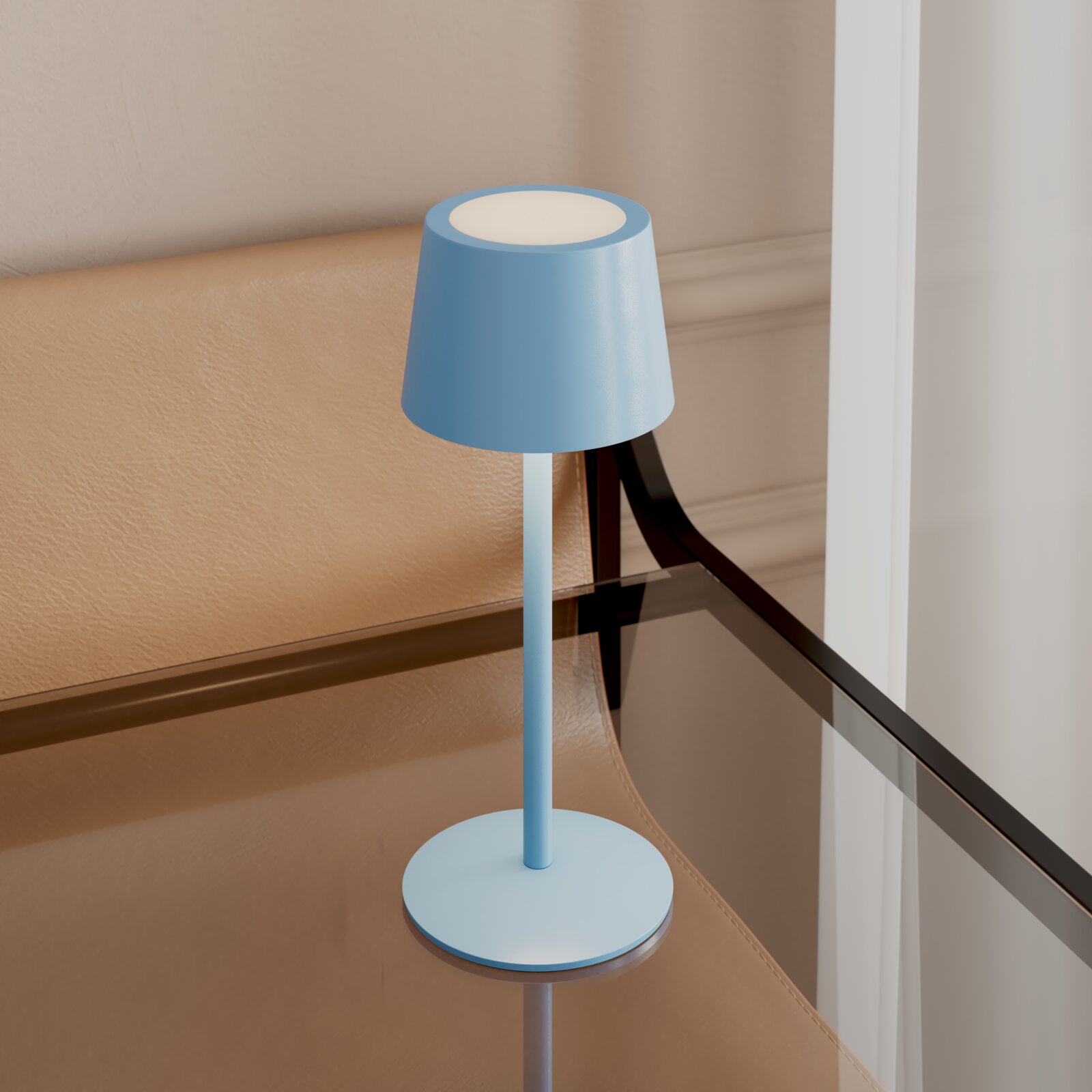 Hellblaue, minimalistische Tischlampe mit zylindrischem Schirm auf rundem Standfuß, auf einem Glastisch neben einem beigen Sessel, in leicht erhöhter Frontansicht.