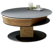 Moderner Couchtisch mit runder, grauer Tischplatte und Holzdetails, seitliche Perspektive