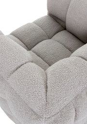 Nahaufnahme eines grauen, gepolsterten Drehsessels mit weicher Textur und quadratischem Muster, von oben betrachtet.